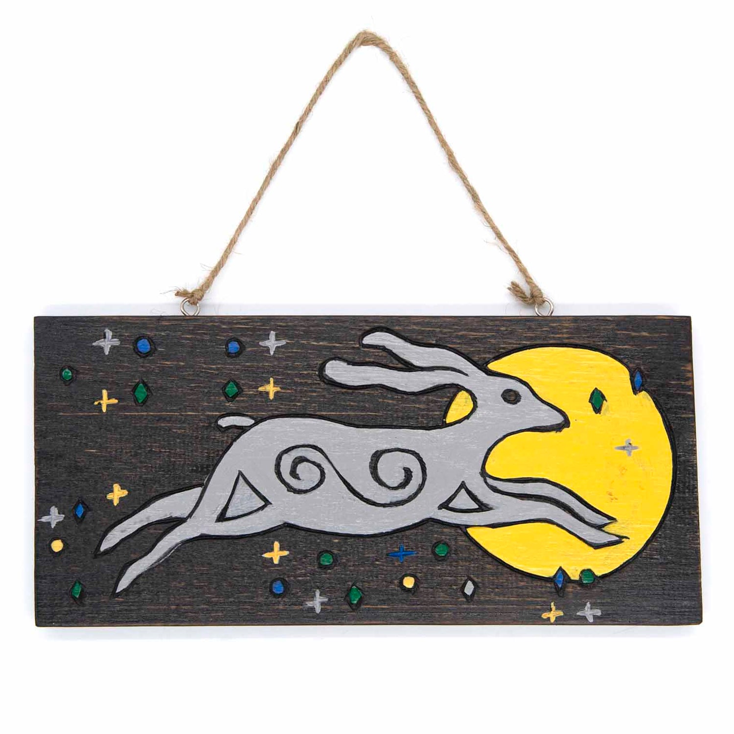 Front view of moon hare wood sign on white background, grey hare with spiral body markings leaping toward a yellow moon, Indo
