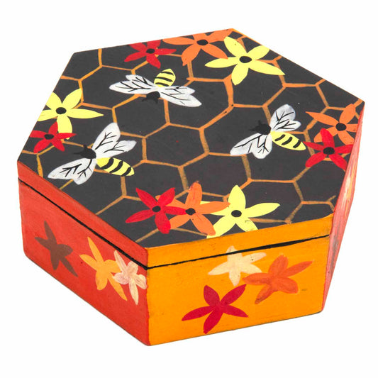 Hexagonal wooden bee box hand-painted with honeycomb, bees and flowers in charcoal, amber and red, three-quarter view