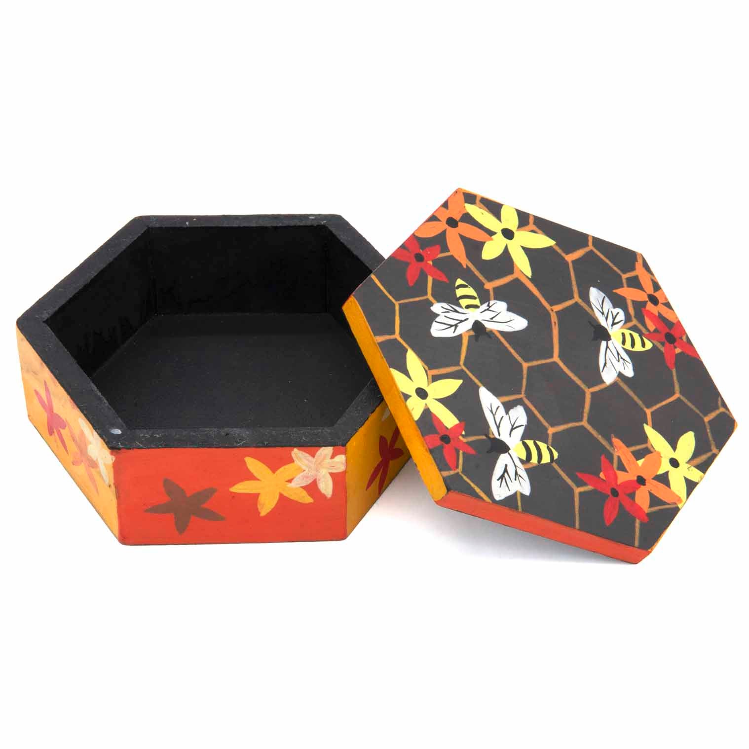 Hexagonal bee box with lid removed showing black interior, honeycomb and bee lid design, Indonesia