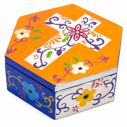 Hand-painted hexagonal cross box in amber orange and cobalt blue, three-quarter view on white background