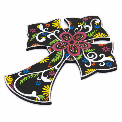 Painted floral cross plaque at an angle showing the flat wood profile and bold hand-painted surface
