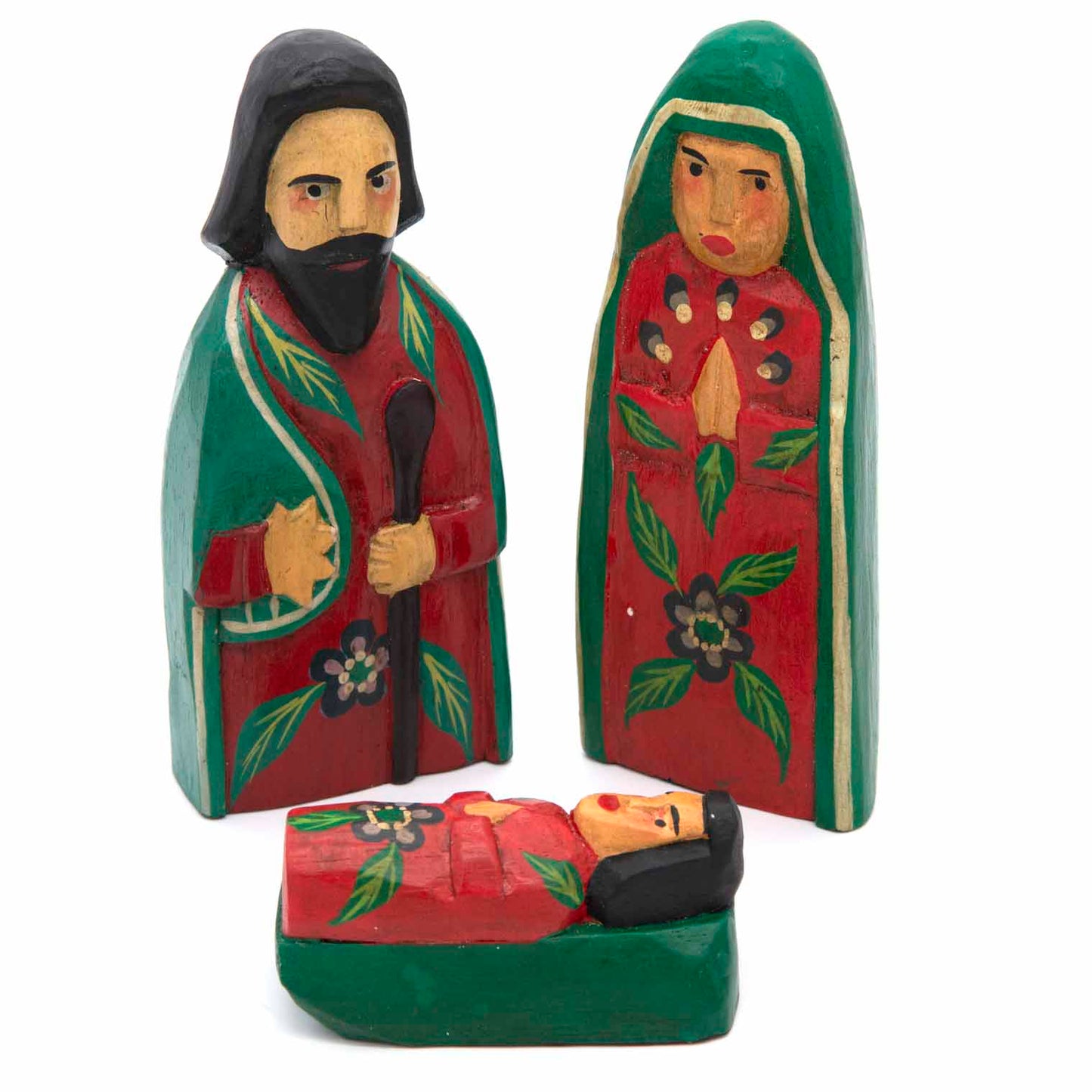 Carved wood nativity set, three figures on white background, front view showing painted leaf and flower motifs