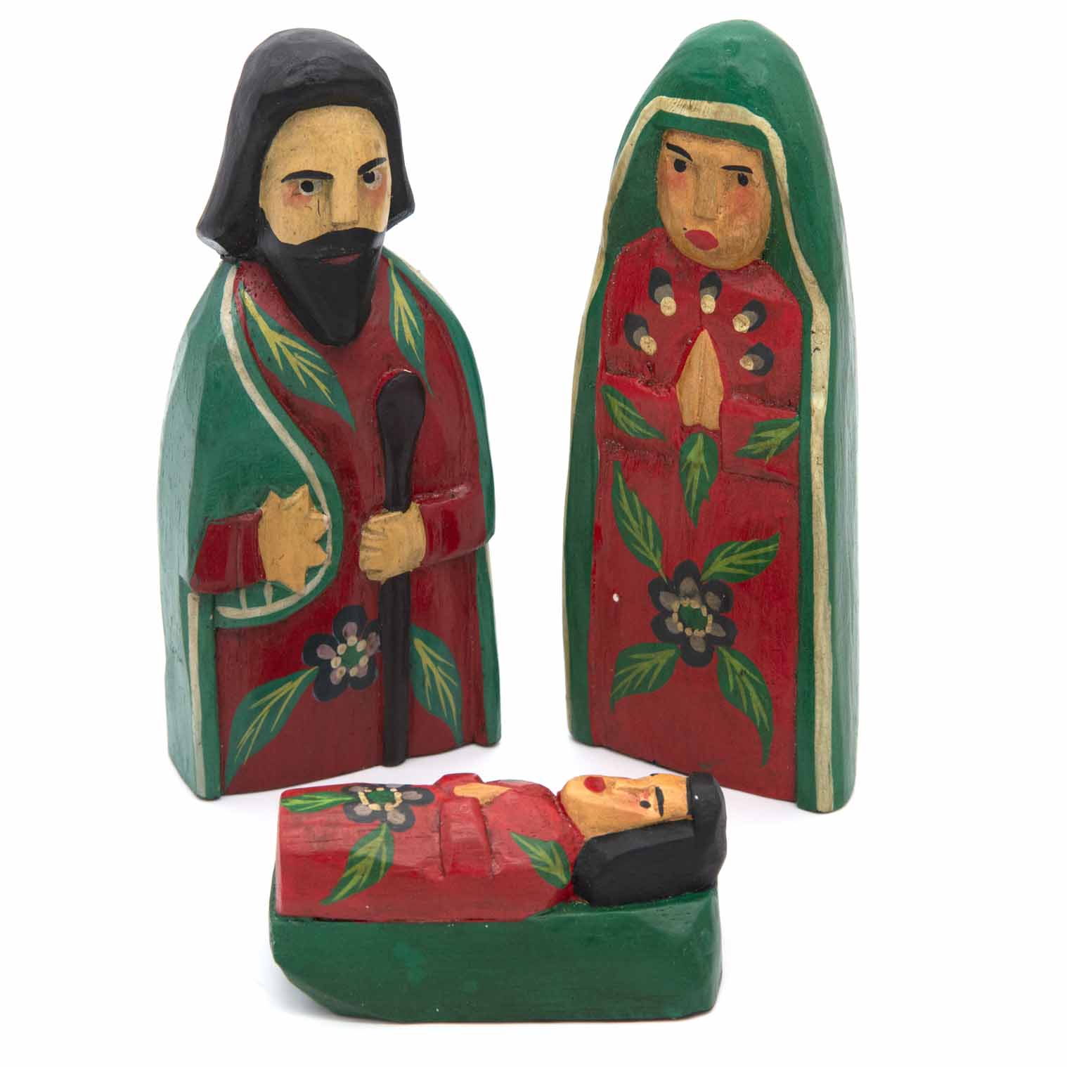 Carved wood nativity set, three figures on white background, front view showing painted leaf and flower motifs
