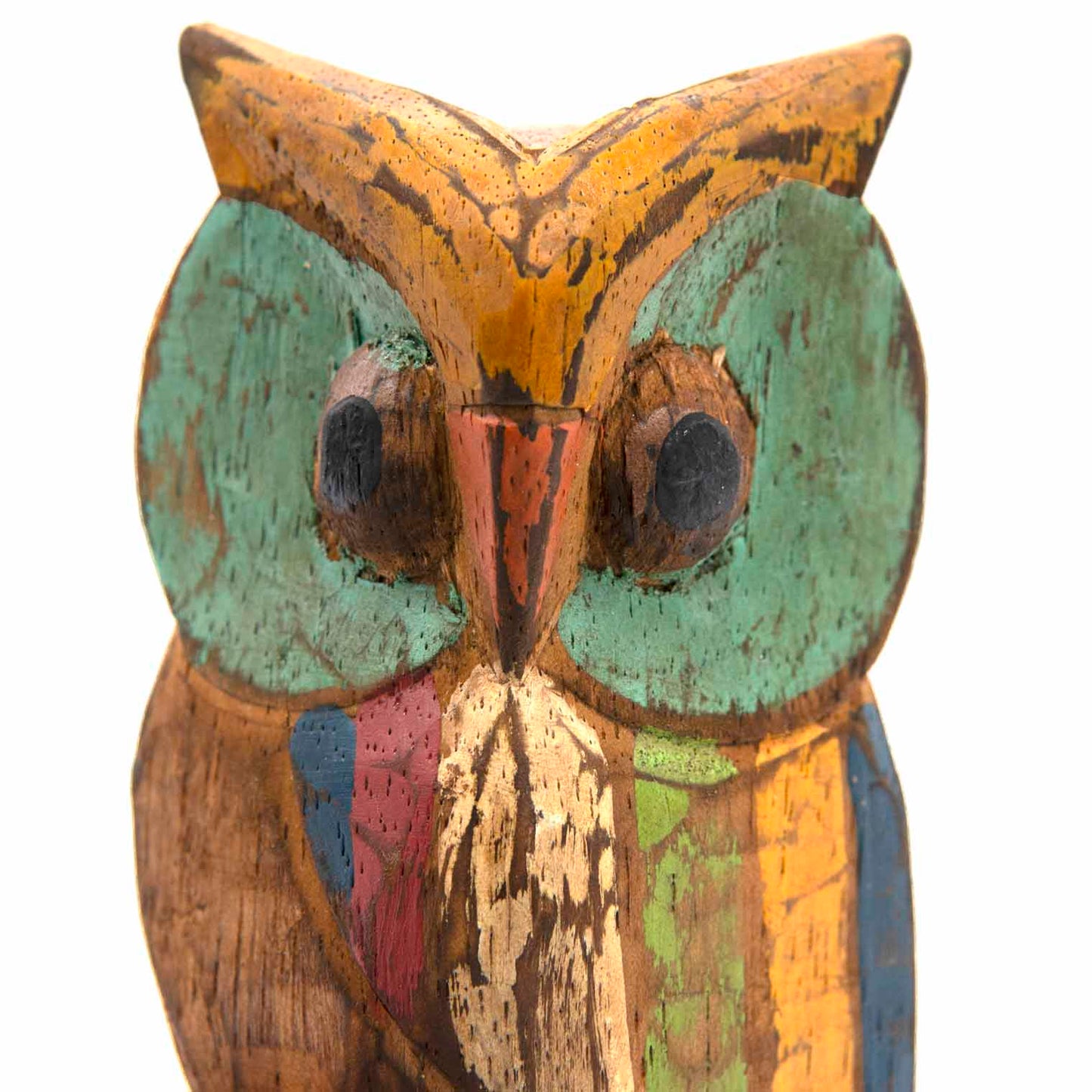 Close-up of painted wooden owl face, teal eyes, red beak and orange ear tufts