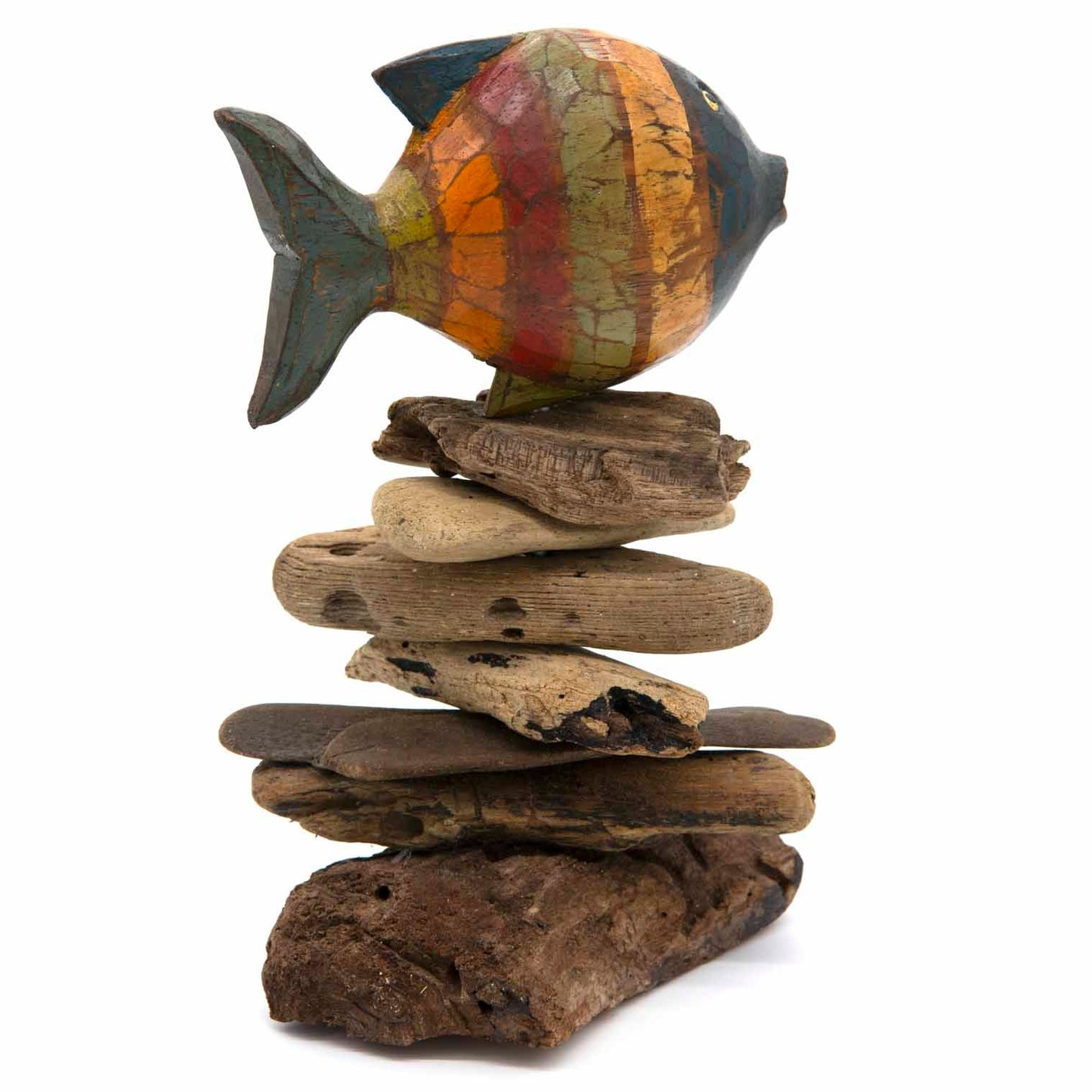 Painted wooden fish with crackled multicolour finish perched on tall driftwood stack