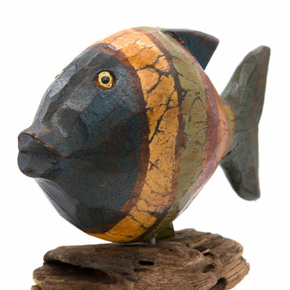 Close-up of carved wooden fish head, slate and gold crackle finish, yellow eye detail