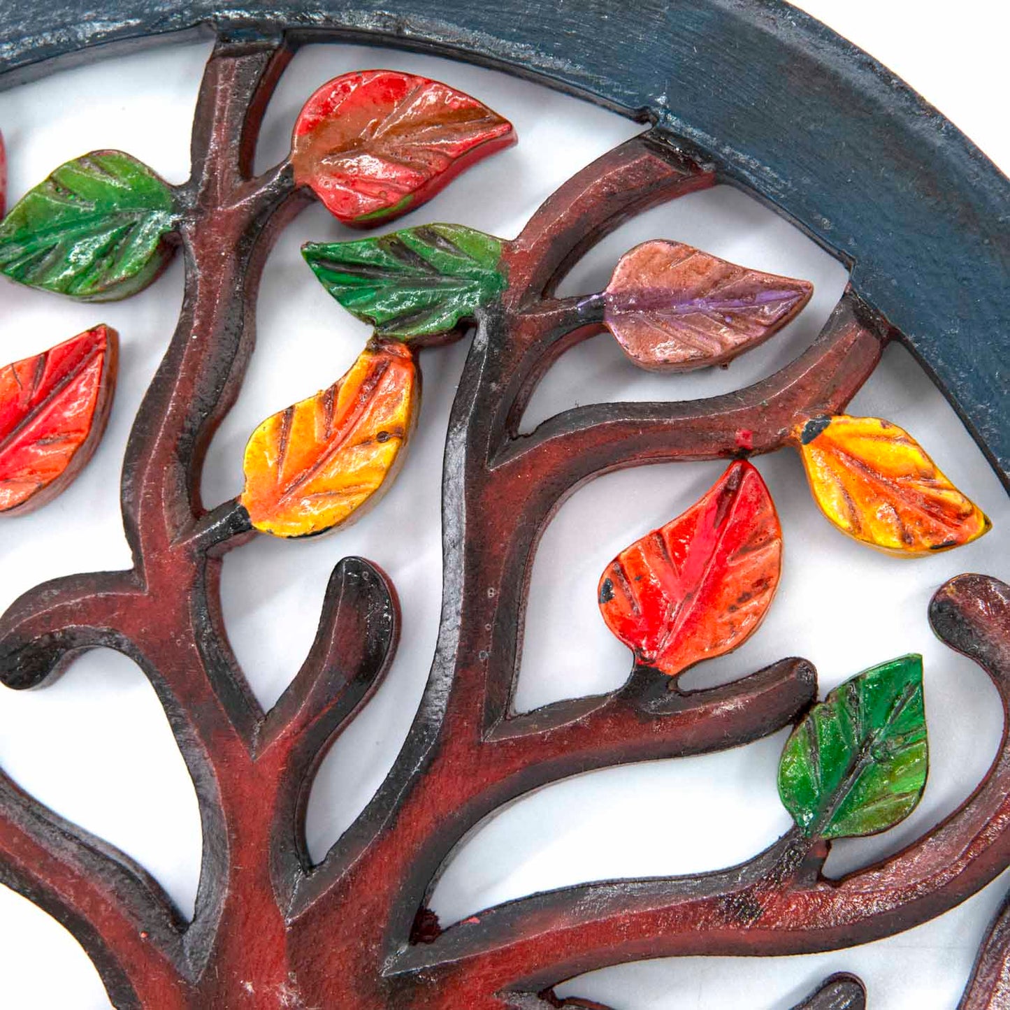 Close-up of hand-painted autumn leaves on Indonesian wood Tree of Life plaque, showing red, orange, amber and green tones