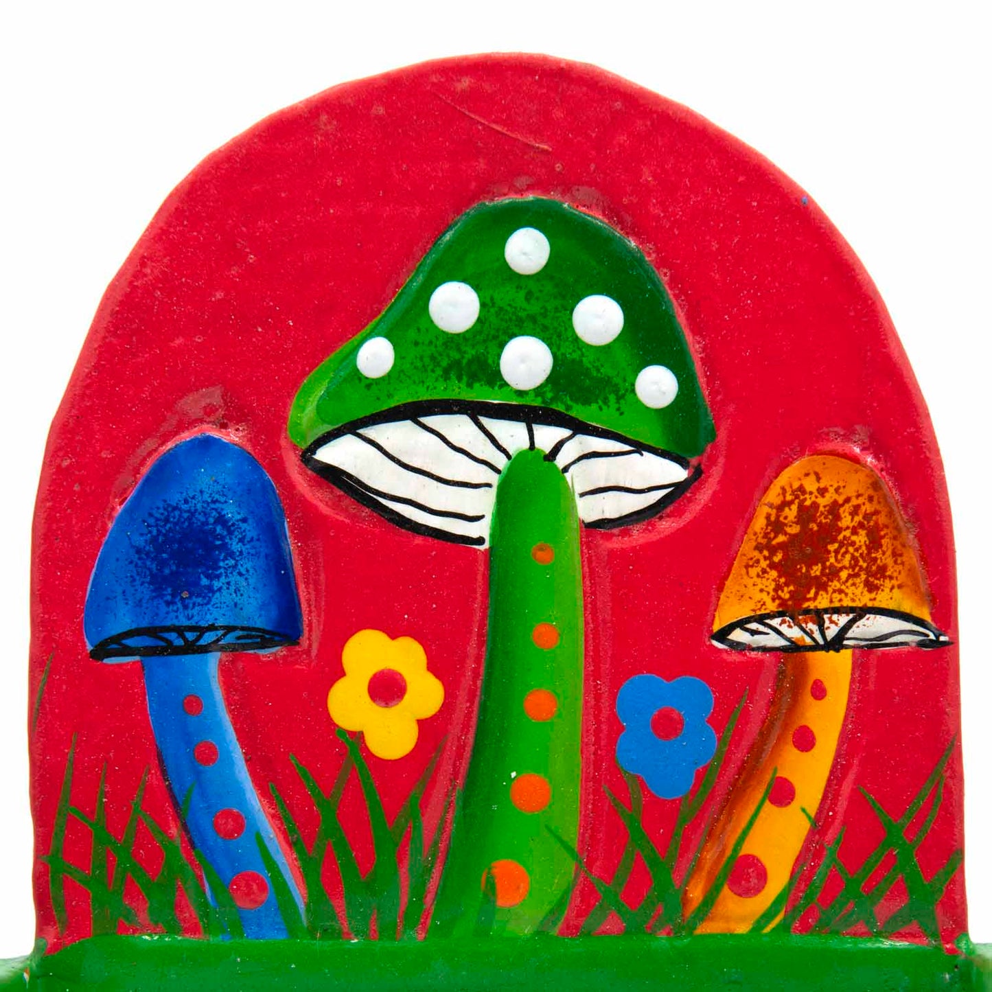 Close-up of painted mushroom scene on red arched backboard showing blue, green and orange toadstools