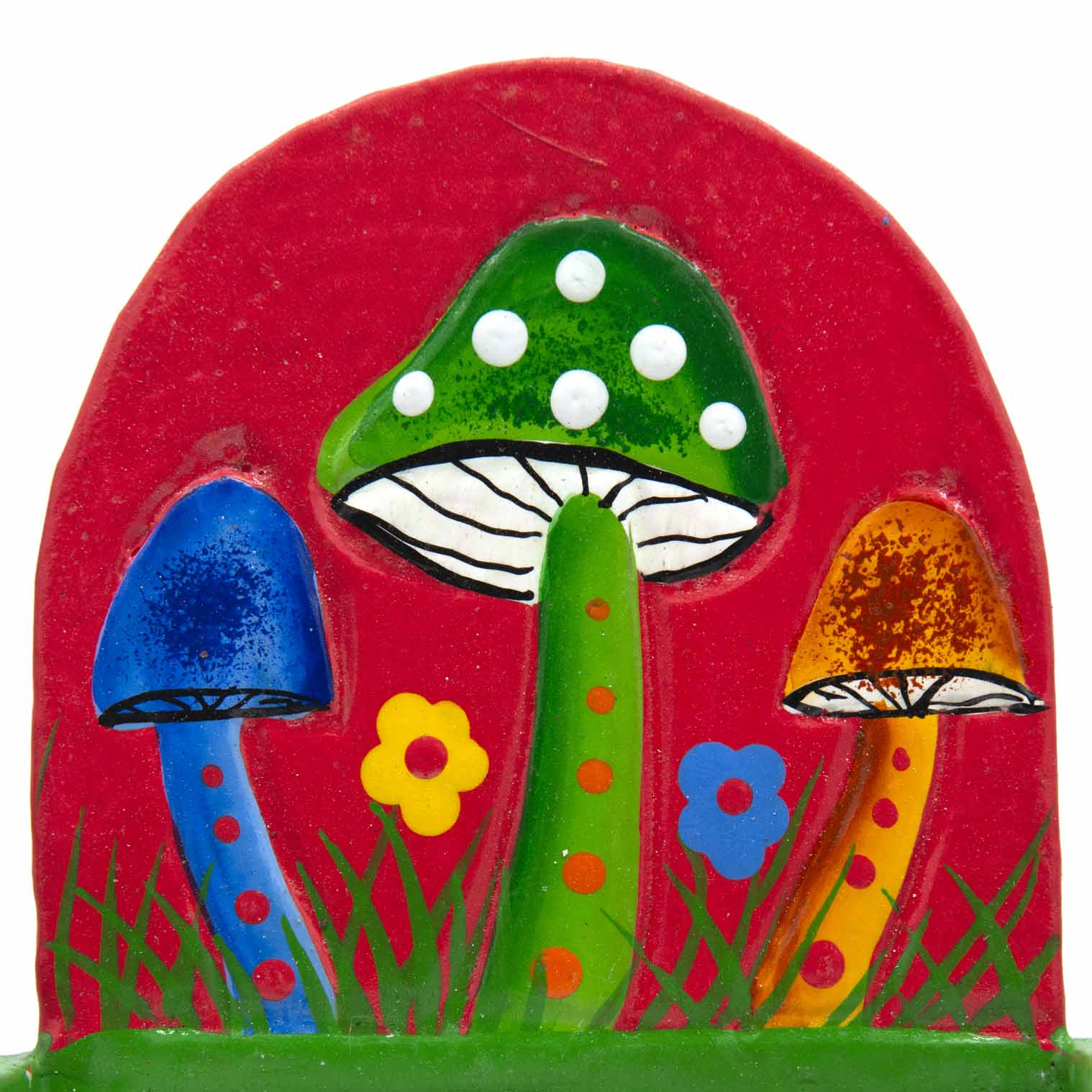 Close-up of painted mushroom scene on red arched backboard showing blue, green and orange toadstools