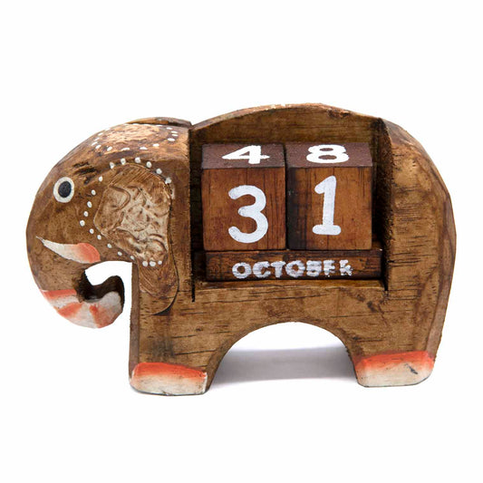 Hand-carved wooden elephant calendar with dark date blocks showing October, side view on white