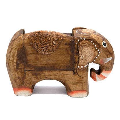 Side profile of small carved dark wood elephant calendar showing full body and block recess