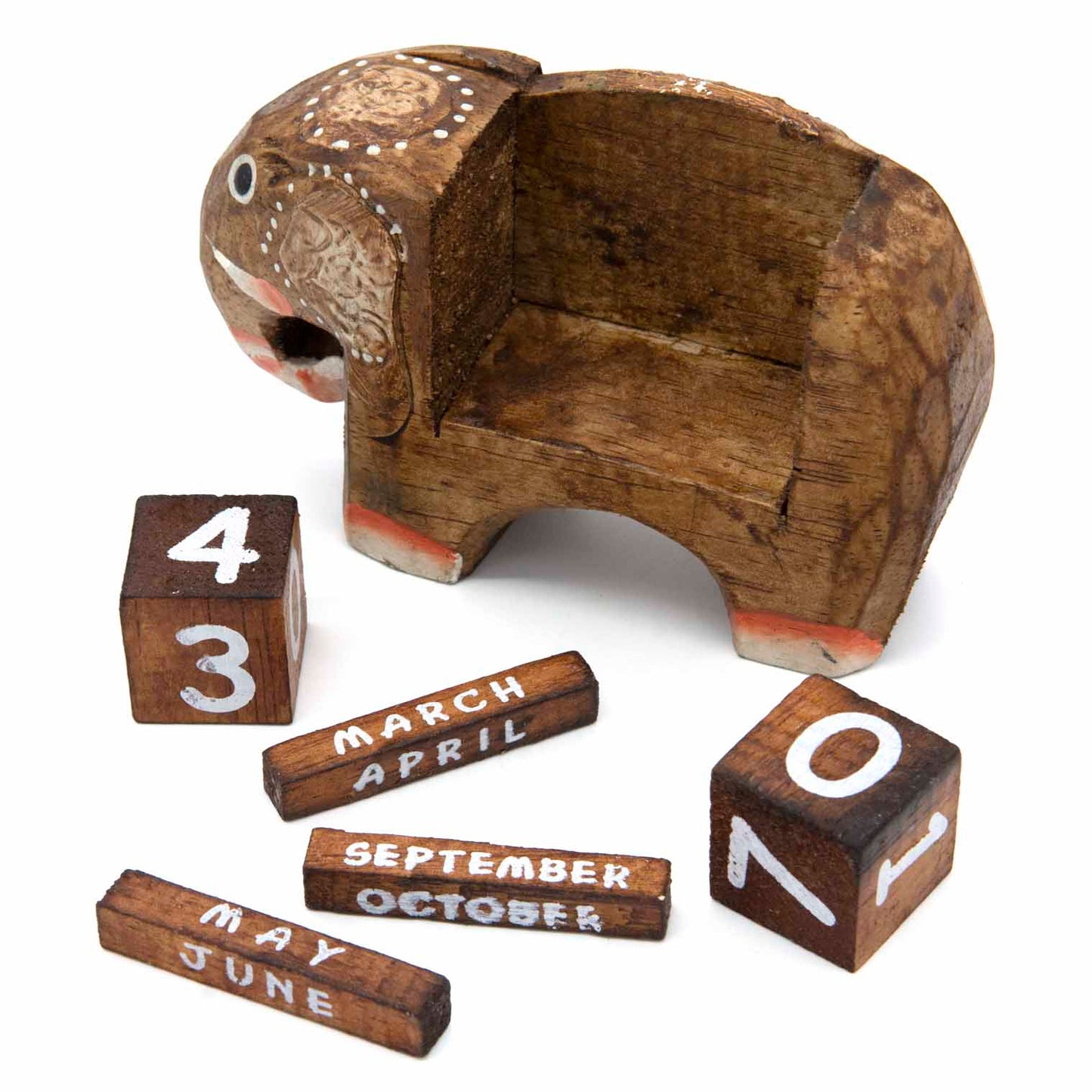 Small carved elephant calendar with dark wood date blocks and month bars laid out separately