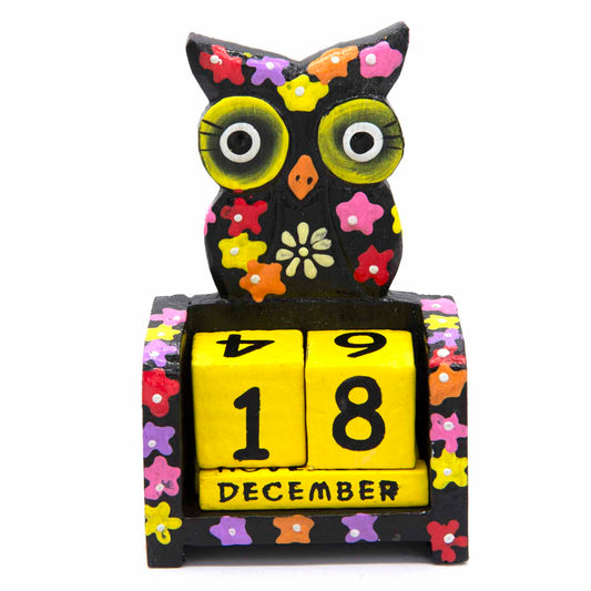 Hand-painted black wooden owl calendar with yellow date blocks showing December, front view on white