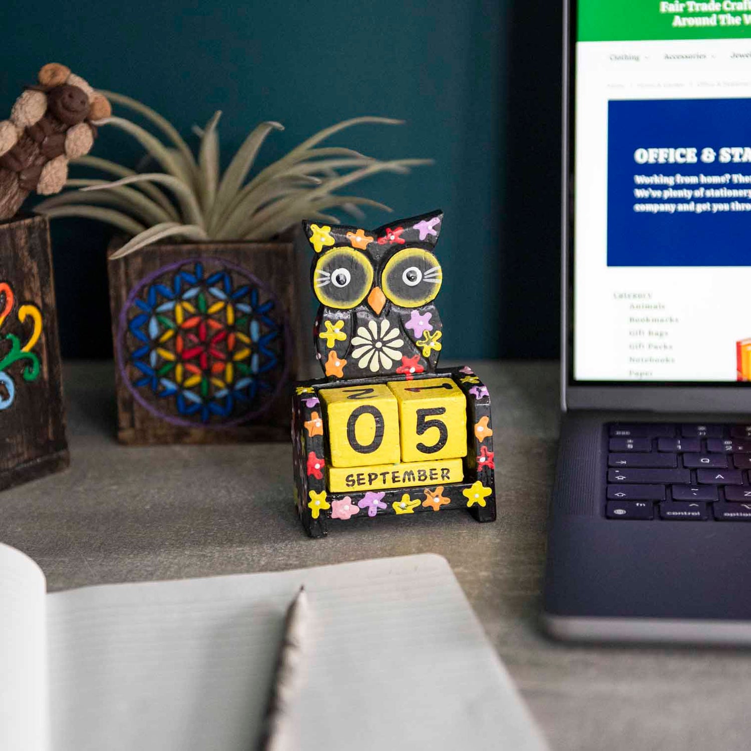Black painted wooden owl perpetual calendar on a desk showing September date, Indonesia