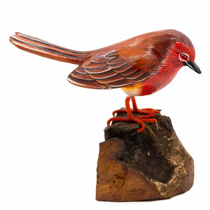 Carved robin figurine, low angle showing red breast fading to yellow belly and wire claws