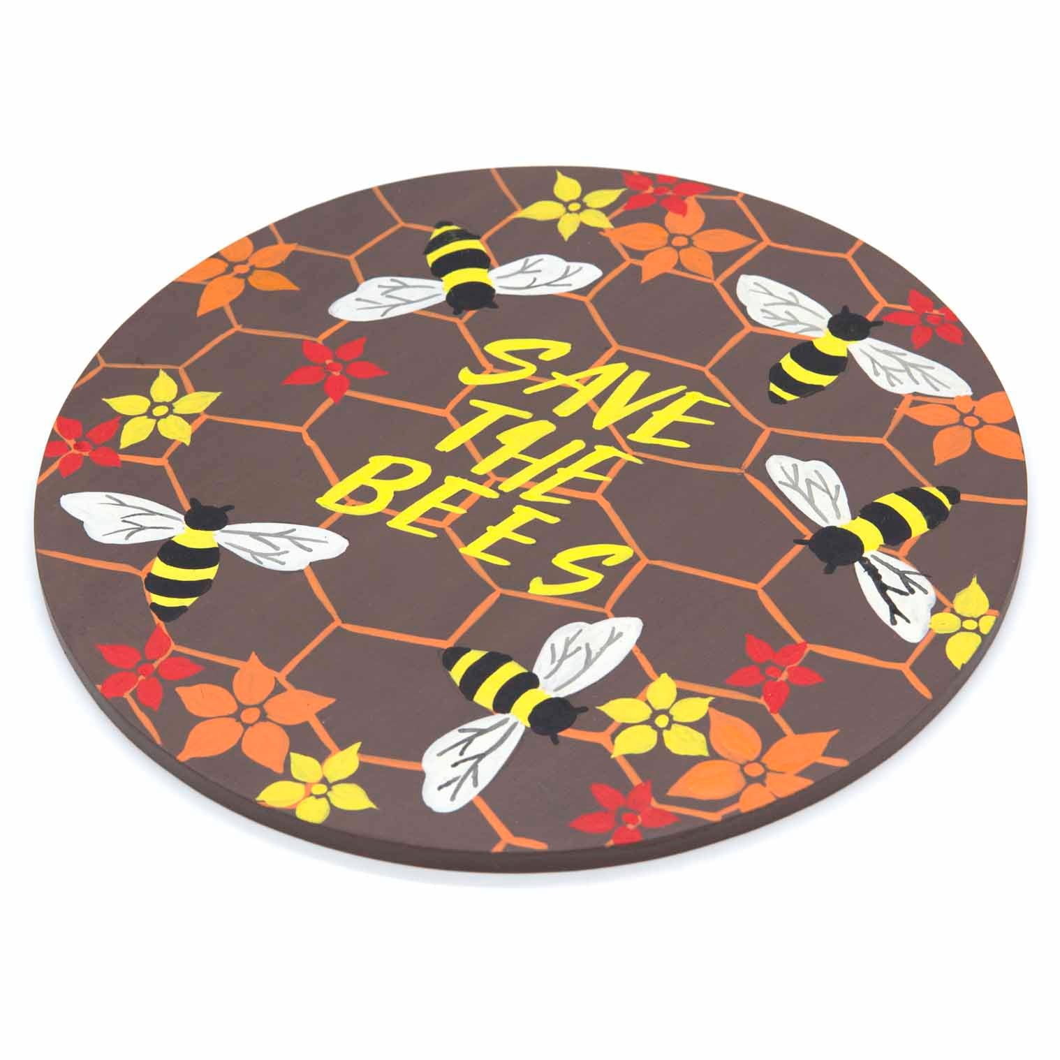 Round bee plaque at an angle on white background showing flat wood profile and painted honeycomb surface