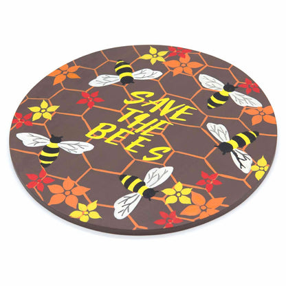 Round bee plaque at an angle on white background showing flat wood profile and painted honeycomb surface