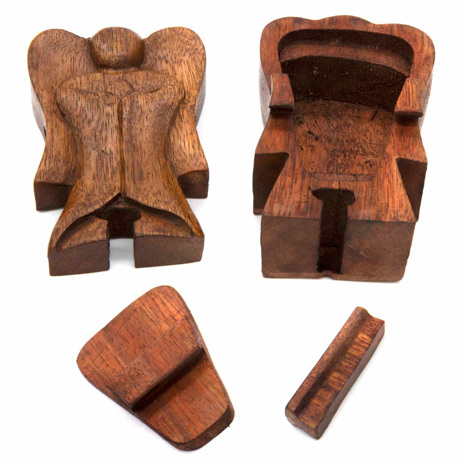 Wooden angel puzzle box disassembled into three parts showing hidden interior compartment, Indonesia