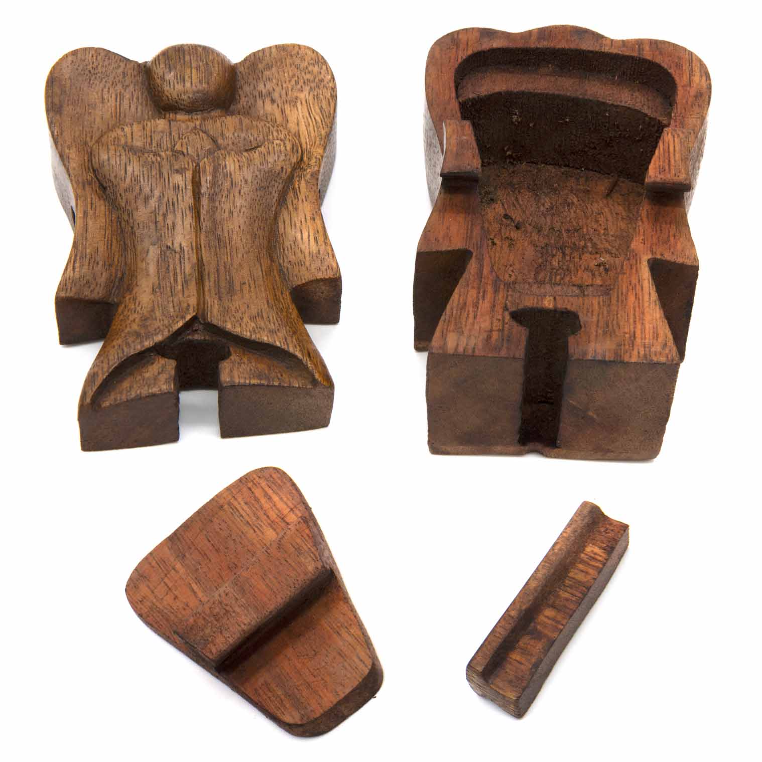 Wooden angel puzzle box disassembled into three parts showing hidden interior compartment, Indonesia