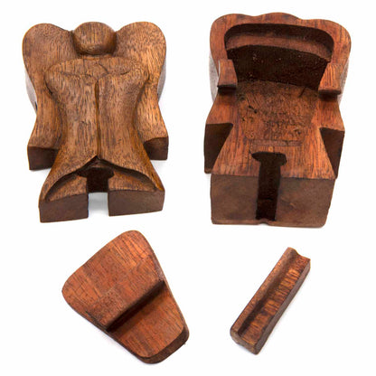Wooden angel puzzle box disassembled into three parts showing hidden interior compartment, Indonesia