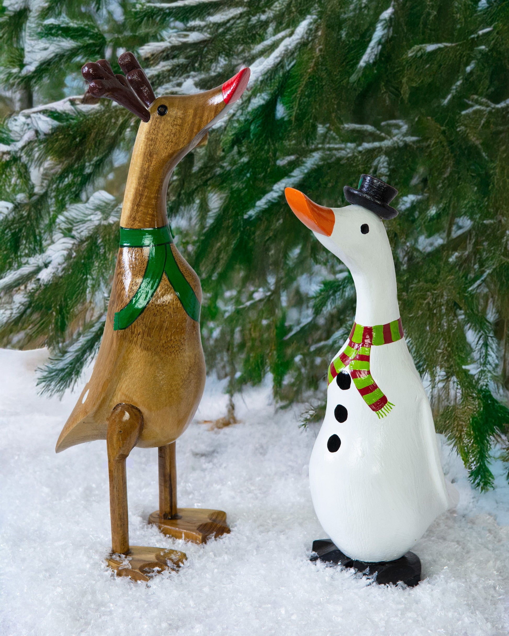 Snowman bamboo duck and reindeer bamboo duck together in snow against pine tree, Bali Indonesia