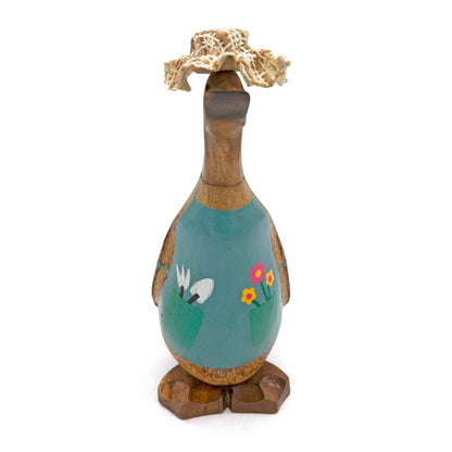 Front-on view of gardening bamboo duck showing full teal apron with tool pocket and flower detail