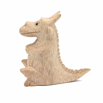 Mini dragon carving, side view showing herringbone spine ridge and swept tail, Indonesia