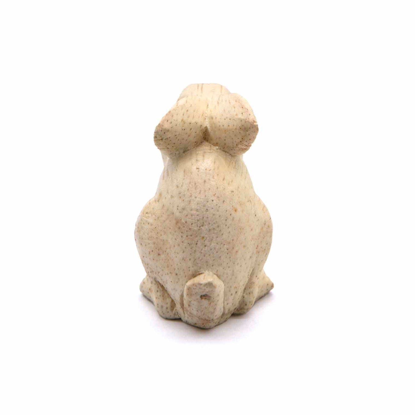 Mini rabbit carving, rear view showing smooth pale wood and tail, Indonesia