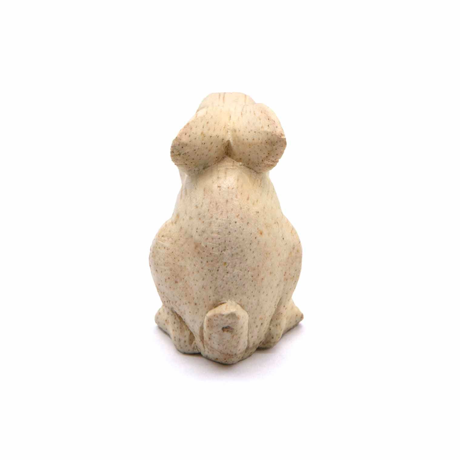 Mini rabbit carving, rear view showing smooth pale wood and tail, Indonesia