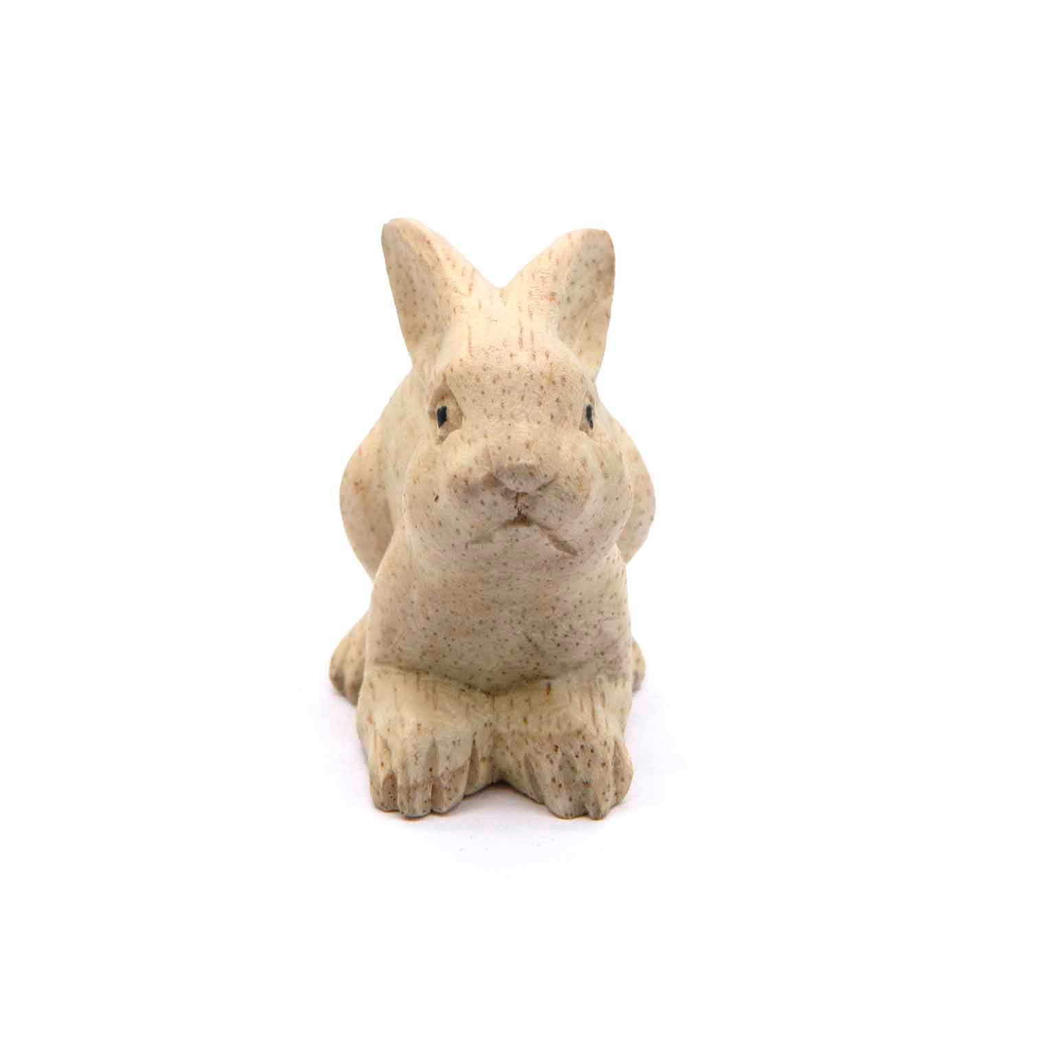Mini wood rabbit carving, front view showing face and front paws, pale natural finish