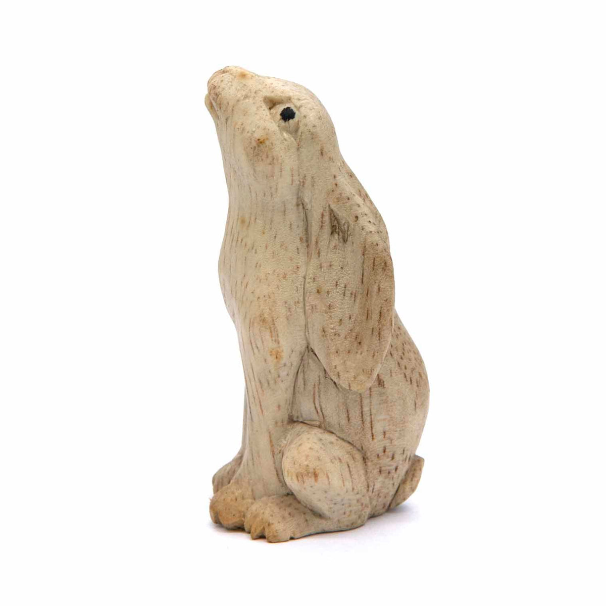 Moon gazing hare carving in pale wood, head tipped back, side view, Indonesia