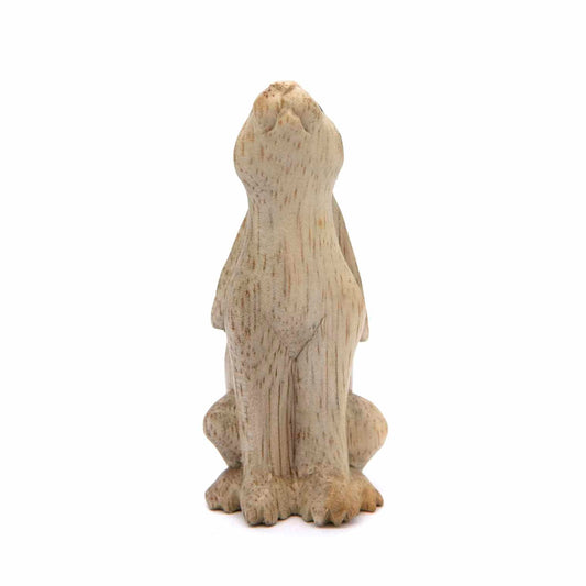 Small carved hare figurine, rear view showing smooth pale wood body and flat ears