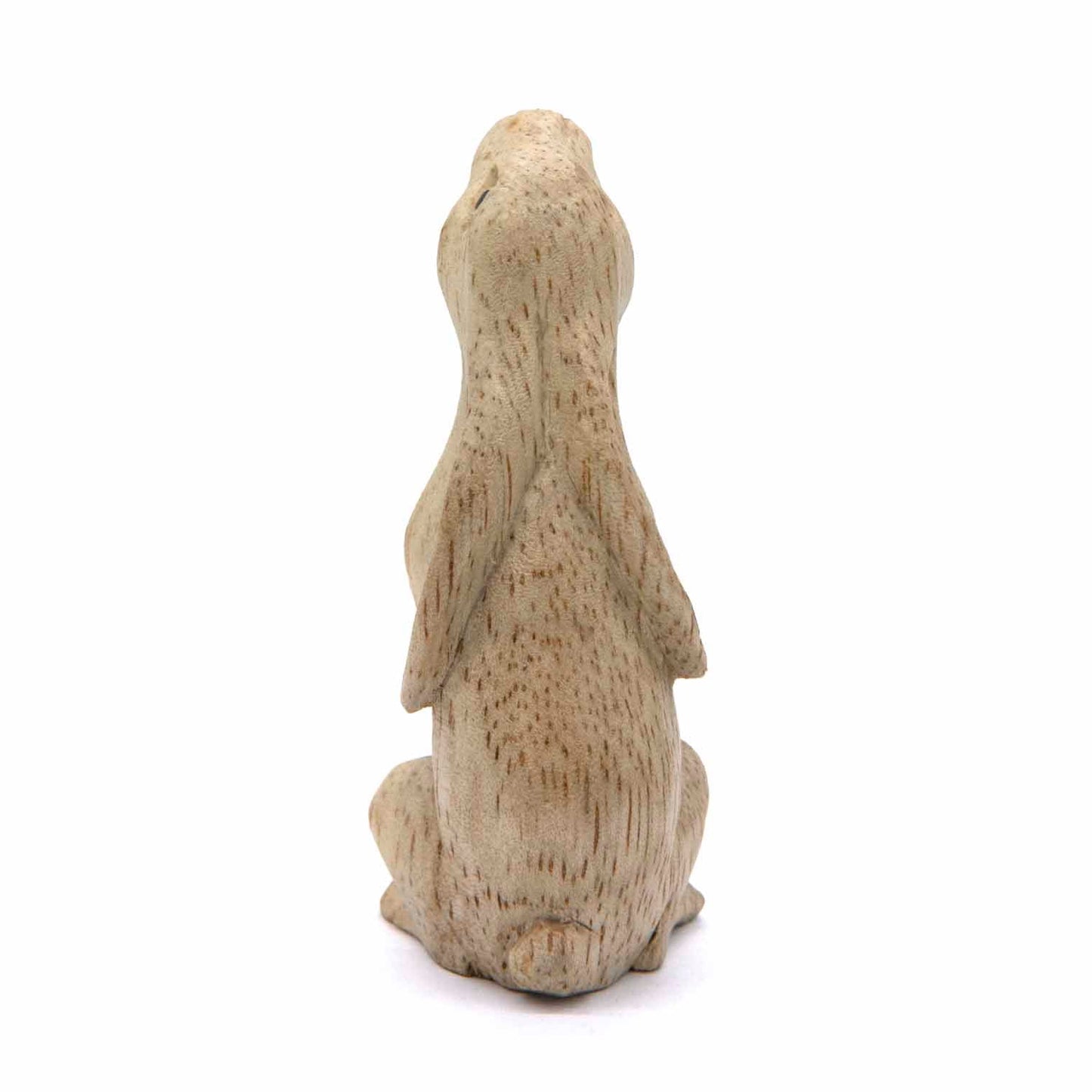 Pale Indonesian wood hare carving, rear three-quarter view showing rounded form and ear texture