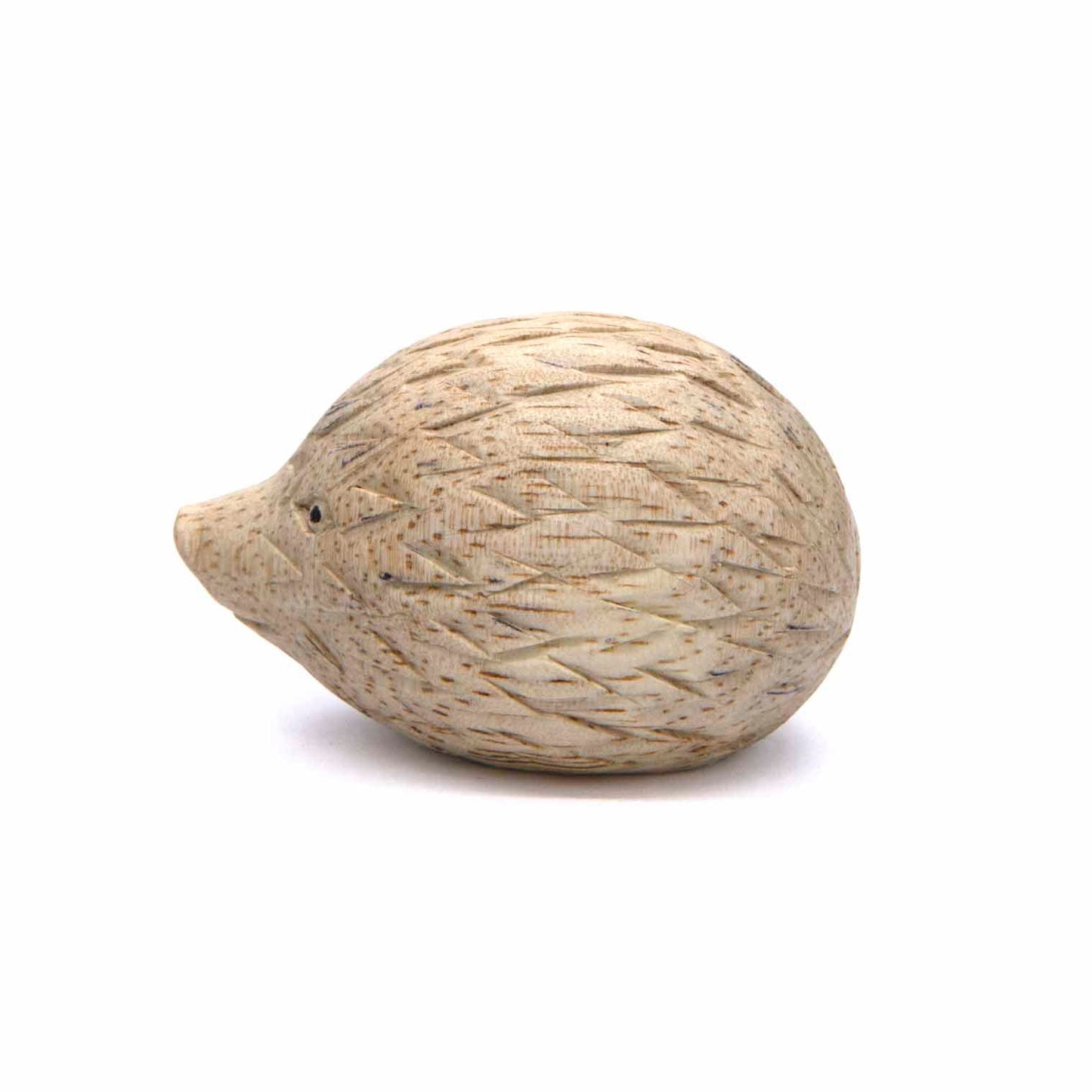Small carved hedgehog figurine, side view showing diamond-cut spine pattern, pale wood