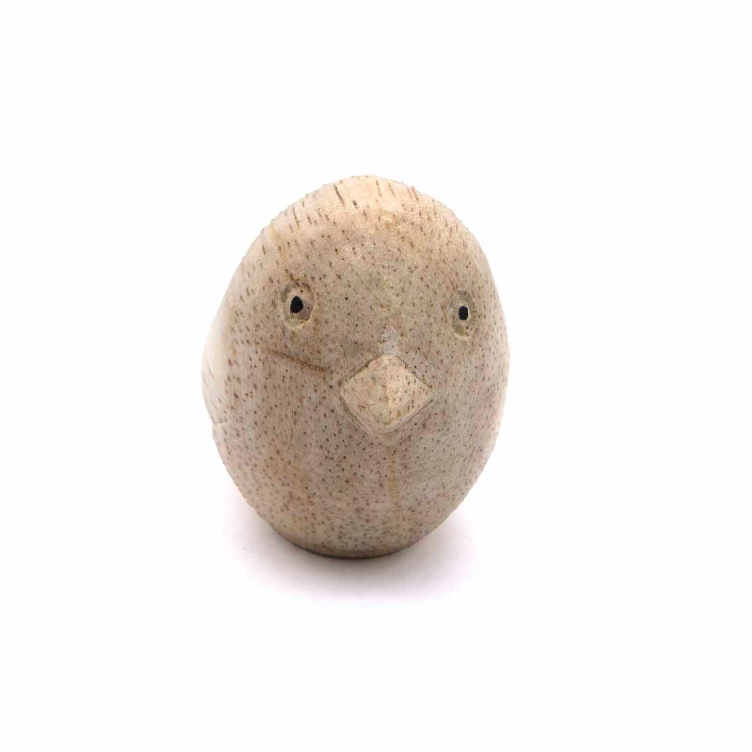 Small carved bird figurine, front view showing round face and beak, pale natural wood