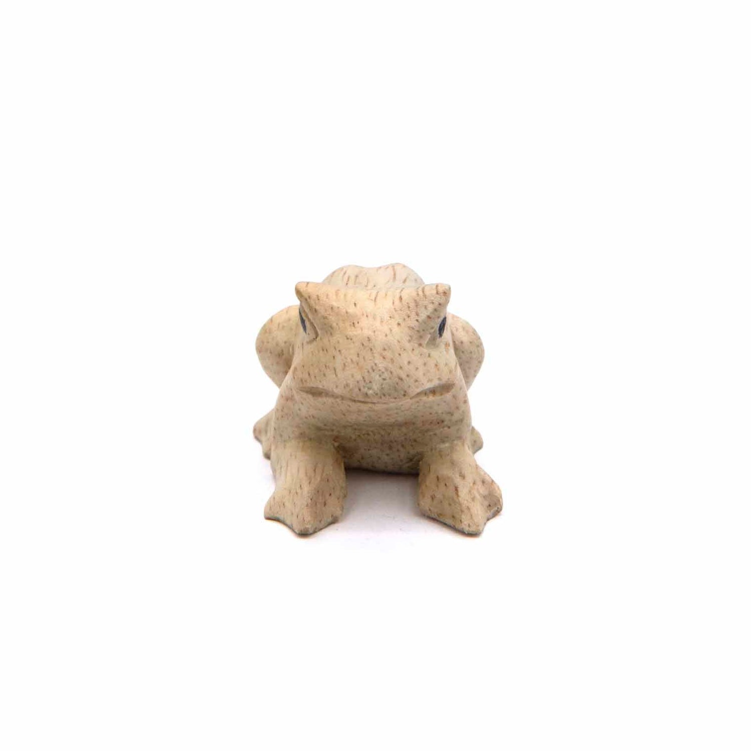 Small carved frog figurine, front view showing face and splayed front legs, pale wood