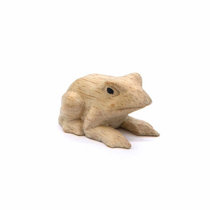 Small Indonesian wood frog carving, three-quarter side view showing compact low form
