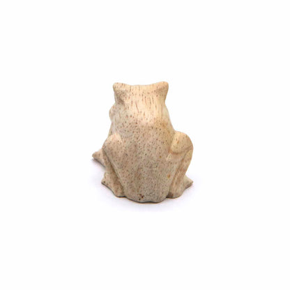 Mini frog wood carving, rear view showing smooth rounded back and tucked hind legs