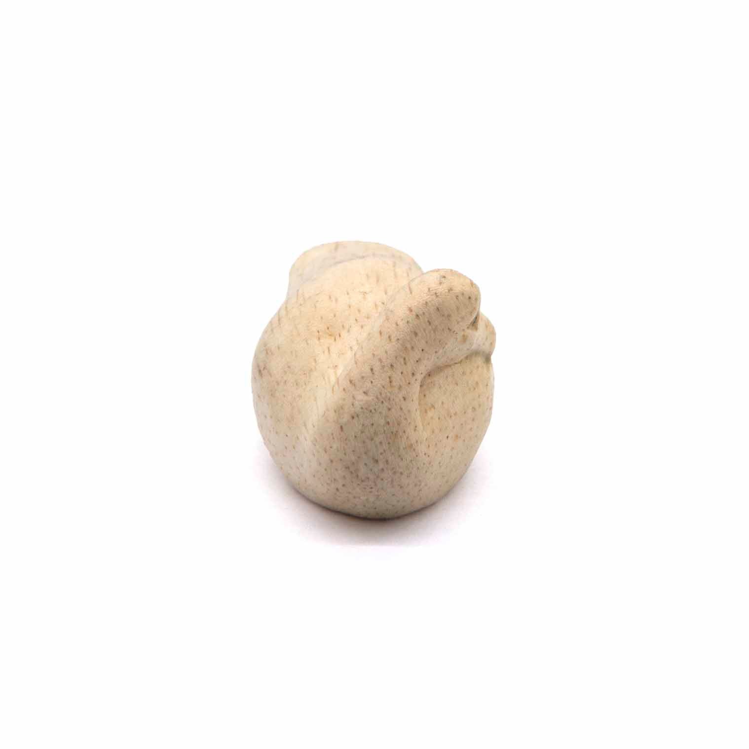 Albizia wood sleeping duck carving viewed from above, showing rounded back and grain detail