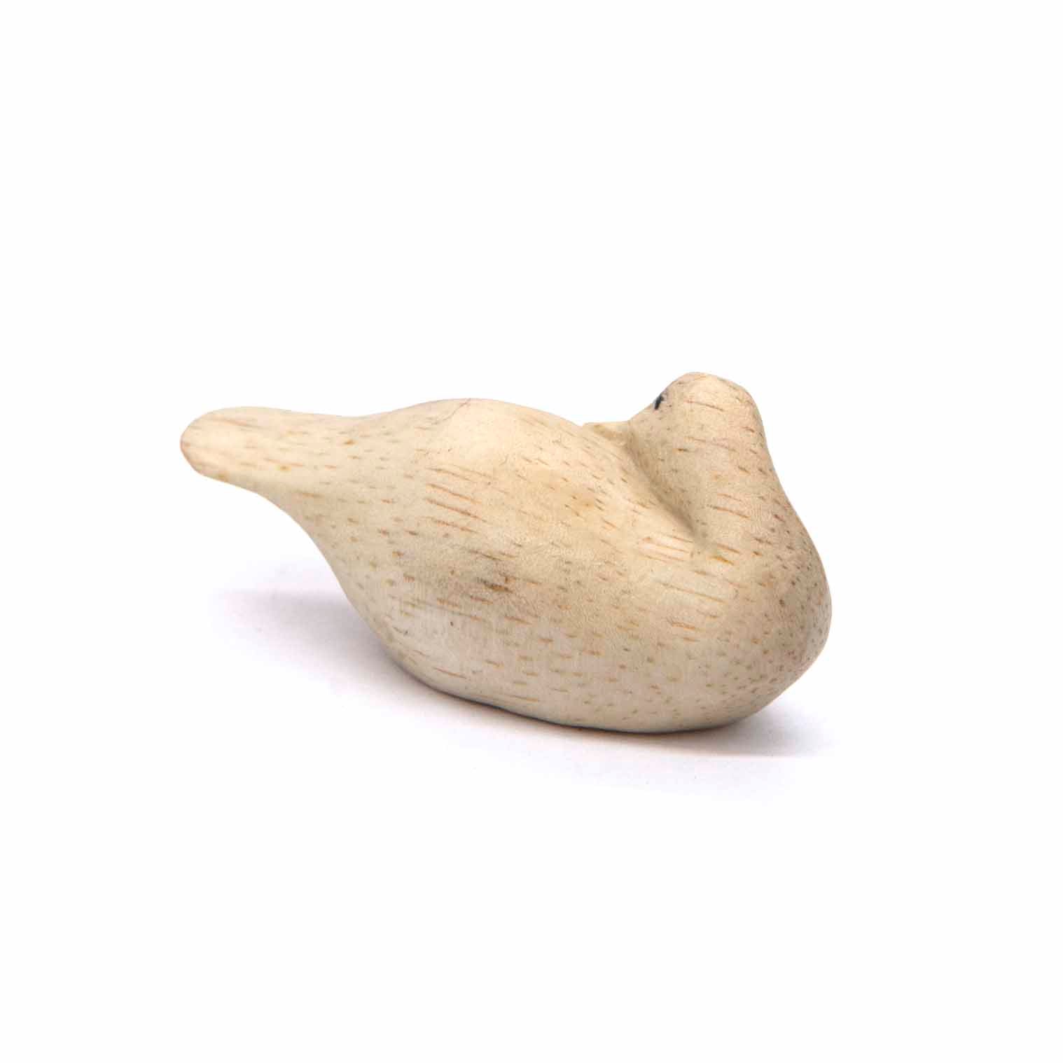 Rear three-quarter view of carved Albizia duck, tail and folded wing visible, Indonesia
