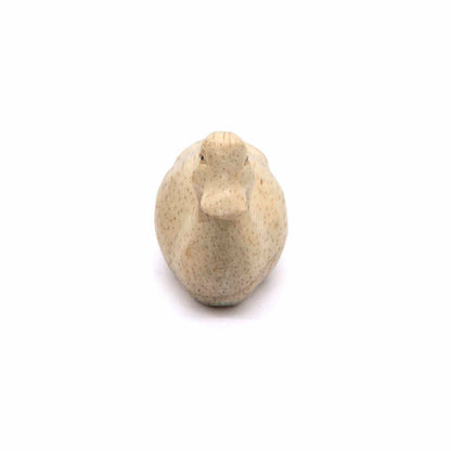 Front-on view of carved Albizia duck, bill and rounded breast visible