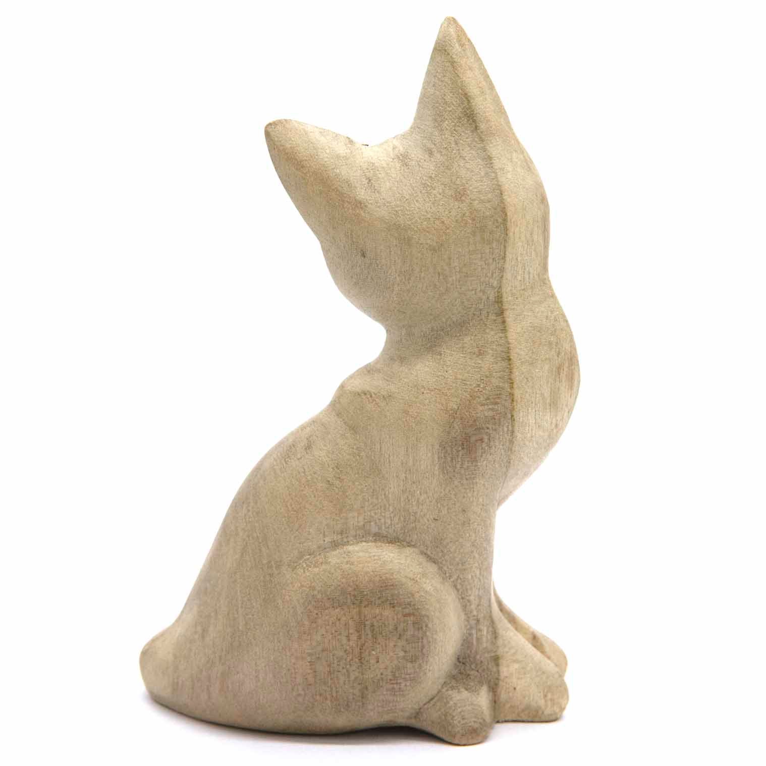 Sitting cat wood carving, rear three-quarter view showing tail curl and back profile