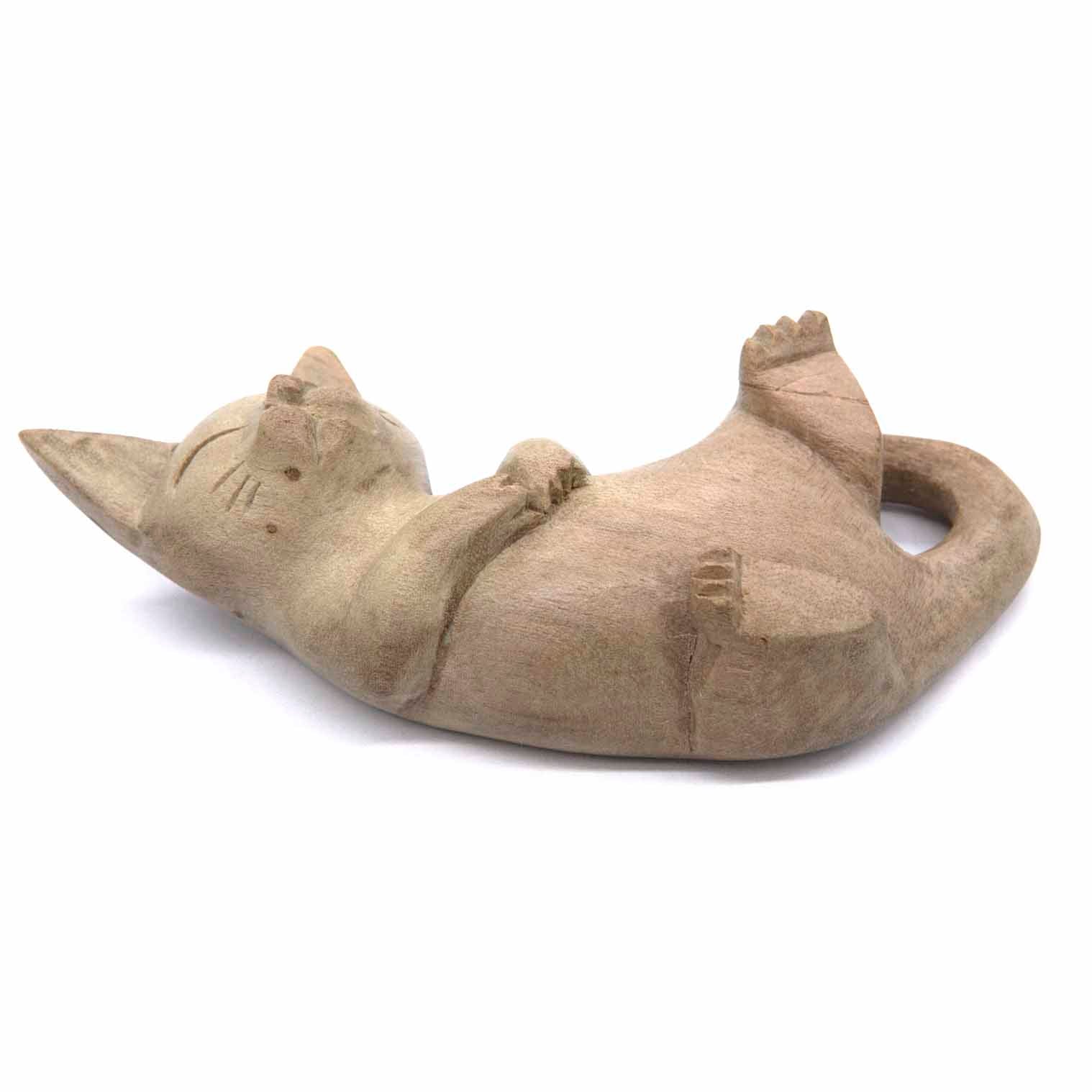 Playing cat wood carving, side view showing cat rolled on back with curved tail, Indonesia