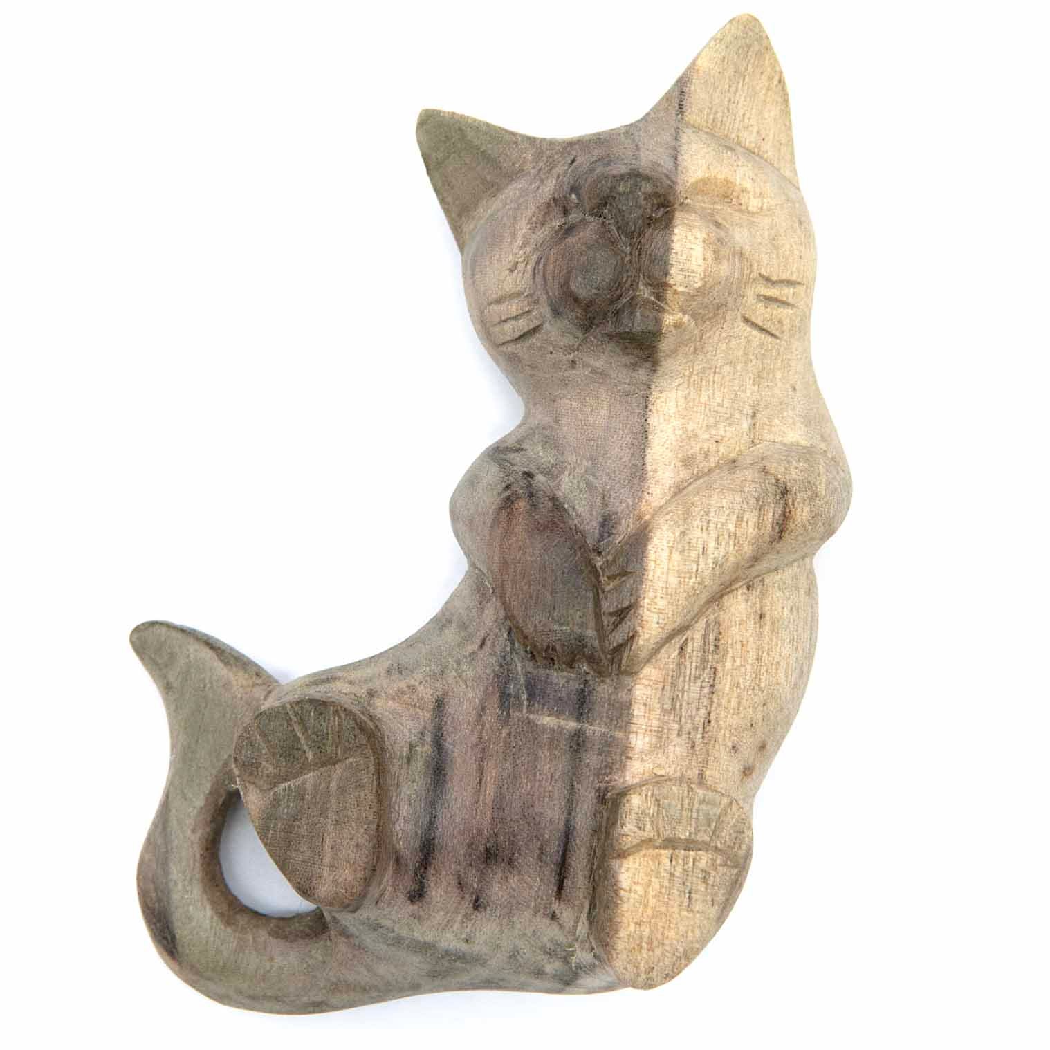 Sitting playing cat carving, front view showing raised paws and grey-stained body markings