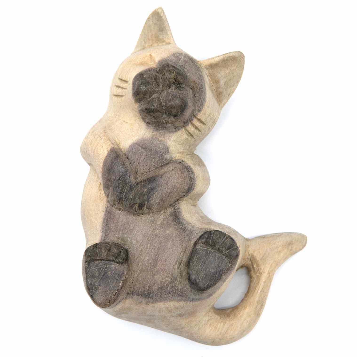 Carved pale wood cat with raised paws, front view showing face and grey-stained markings
