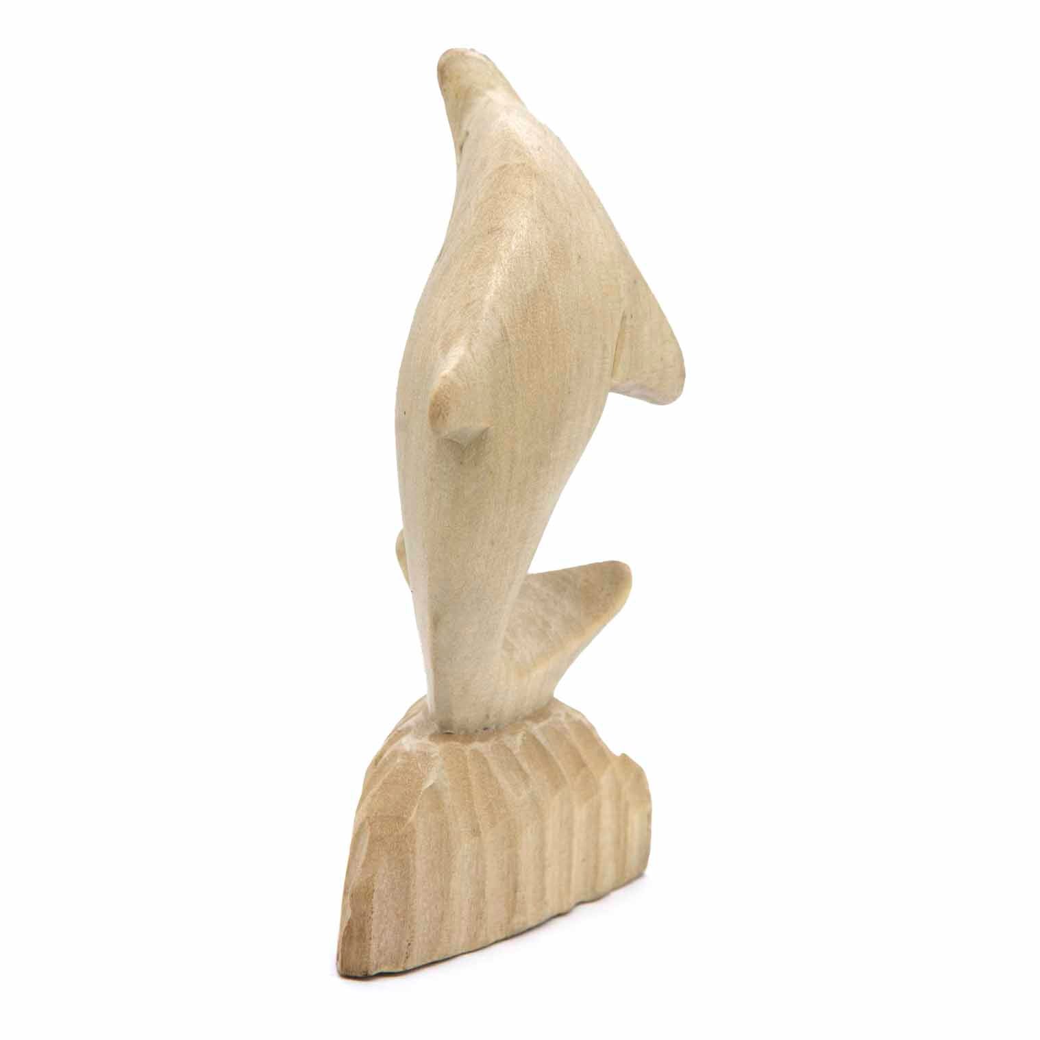 Carved pale wood dolphin, rear three-quarter view showing fin and tail detail