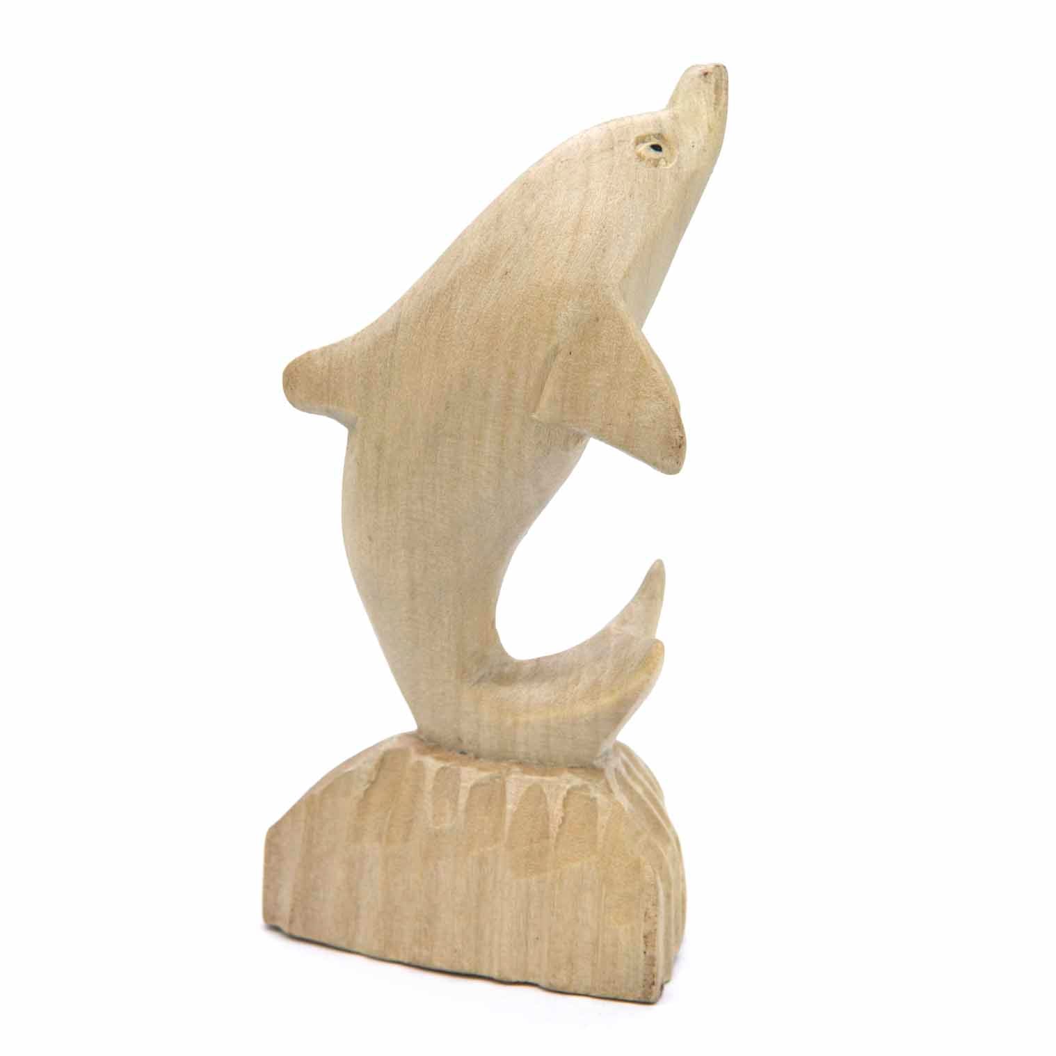 Dolphin wood carving, side view showing arched body and carved wave base, Indonesia