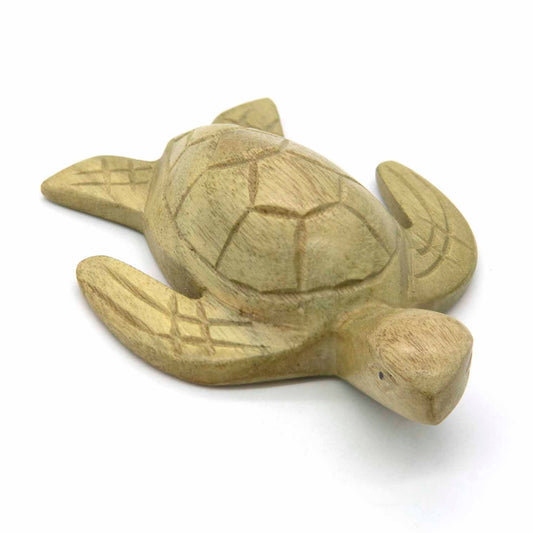 Hand-carved turtle figurine, three-quarter view showing shell pattern and head detail