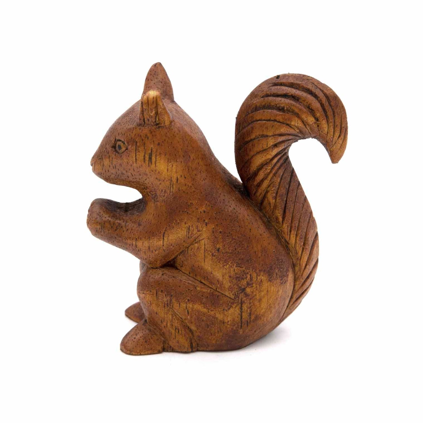 Carved squirrel figurine, side view showing alert posture and fan tail, amber-stained wood