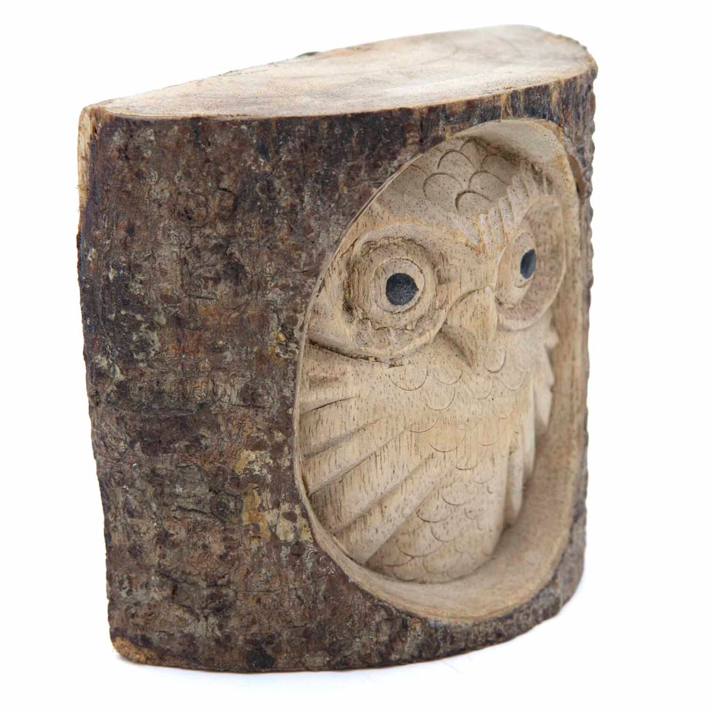 Carved owl log section, angled side view showing depth of relief carving and rough bark edge, Indonesia